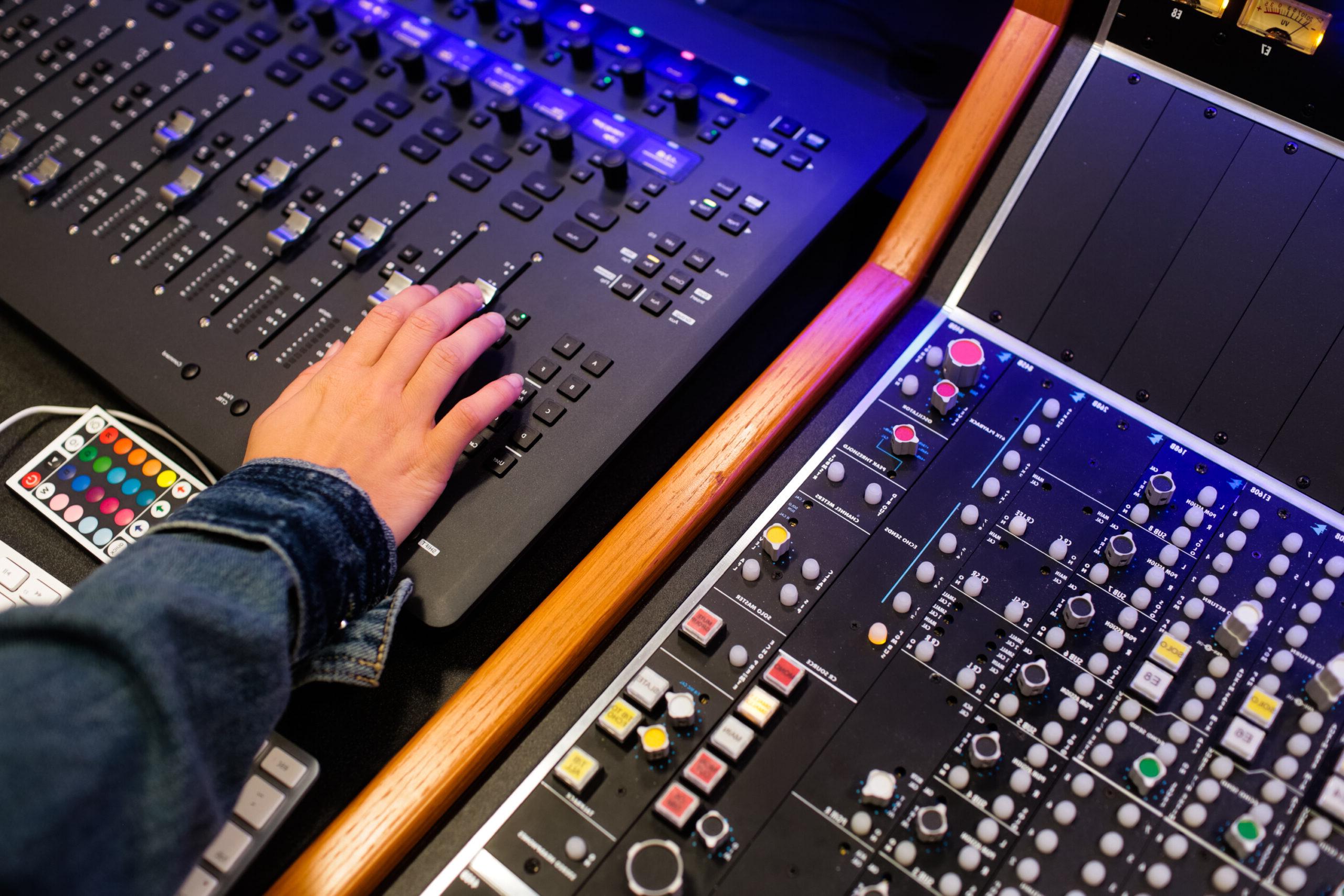 student's hand working on a sound board